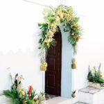 Church door garland with bright colours and hanging pineapples tropical birds theme