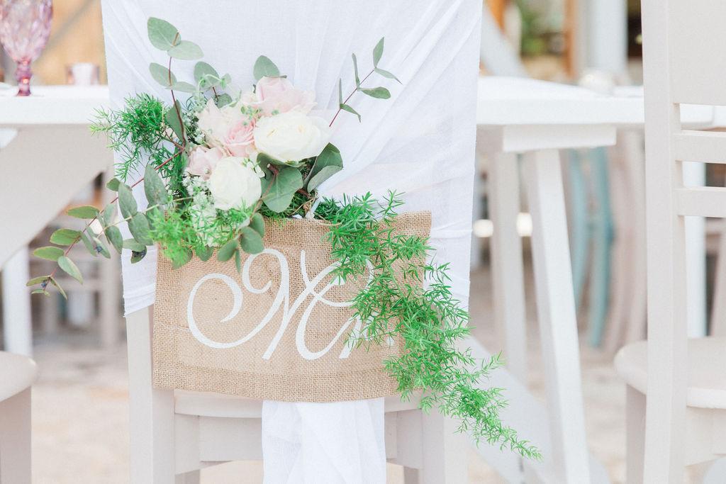 Wedding chair decoration with hessian sign and pastel flowers